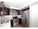 Modern kitchen with stainless steel appliances and dark wood cabinets at 7950 E Camelback Rd # 512, Scottsdale, AZ 85251