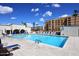 Community pool with lounge chairs and building in background at 7950 E Camelback Rd # 512, Scottsdale, AZ 85251