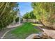 Landscaped backyard with lush lawn and mature trees at 8008 E Del Rubi Dr, Scottsdale, AZ 85258