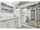 Modern bathroom with double vanity, mirrored closet, and zebra print rug at 8008 E Del Rubi Dr, Scottsdale, AZ 85258