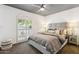 Spacious bedroom with gray bedding and built-in shelving at 8008 E Del Rubi Dr, Scottsdale, AZ 85258