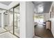 View of bedroom and bathroom with mirrored closet doors and carpeted floor at 8008 E Del Rubi Dr, Scottsdale, AZ 85258