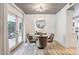 Small dining area with a round glass table and four velvet chairs at 8008 E Del Rubi Dr, Scottsdale, AZ 85258