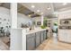 Gray kitchen island and white cabinetry, open to living area at 8008 E Del Rubi Dr, Scottsdale, AZ 85258