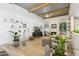 Living area featuring hardwood floors, exposed beams, and a cozy fireplace at 8008 E Del Rubi Dr, Scottsdale, AZ 85258