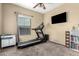 Bright bedroom with treadmill, window, and built-in shelving at 900 S 94Th St # 1001, Chandler, AZ 85224