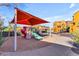 Community playground with shade structure and play equipment at 900 S 94Th St # 1066, Chandler, AZ 85224