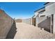 Backyard with gravel, block wall, and gate at 9089 W Troy Dr, Arizona City, AZ 85123