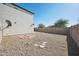 Spacious backyard with gravel and a block wall at 9089 W Troy Dr, Arizona City, AZ 85123