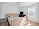 Light and airy bedroom with wood bed frame and window at 9089 W Troy Dr, Arizona City, AZ 85123