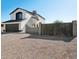 Two-story house with a brown gate and gravel landscaping at 9089 W Troy Dr, Arizona City, AZ 85123