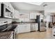 Kitchen with white cabinets, stainless steel appliances, and tile floor at 9089 W Troy Dr, Arizona City, AZ 85123