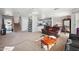 Living room with stairs, a brown couch, and kitchen view at 9089 W Troy Dr, Arizona City, AZ 85123