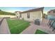 Large backyard with artificial turf and a paved patio area at 9136 E Plata Ave, Mesa, AZ 85212