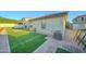 Artificial turf, paved pathway, and a view of the home's exterior at 9136 E Plata Ave, Mesa, AZ 85212