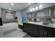 Elegant bathroom with double sinks, a soaking tub, and modern fixtures at 9136 E Plata Ave, Mesa, AZ 85212