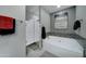 Relaxing bathroom with a soaking tub, modern tile, and a barn door at 9136 E Plata Ave, Mesa, AZ 85212