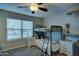 Well-lit bedroom featuring a bunk bed, window blinds, and nightstands at 9136 E Plata Ave, Mesa, AZ 85212