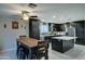 Eat-in kitchen with farmhouse table and dark cabinetry at 9136 E Plata Ave, Mesa, AZ 85212