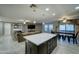 Modern kitchen with large island, dark cabinets and open layout at 9136 E Plata Ave, Mesa, AZ 85212