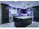 Sleek kitchen with dark cabinets, quartz countertops, and under-cabinet lighting at 9136 E Plata Ave, Mesa, AZ 85212