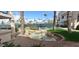 Landscaped backyard with pond, palm trees and tennis court at 9707 E Mountain View Rd # 1430, Scottsdale, AZ 85258