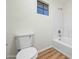 Clean bathroom with a tub, toilet and wood-look floors at 9920 W Calle Encorvada --, Phoenix, AZ 85037