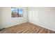 Simple bedroom with wood-look floors and sliding doors at 9920 W Calle Encorvada --, Phoenix, AZ 85037