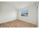 Bright bedroom with wood-look floors and window at 9920 W Calle Encorvada --, Phoenix, AZ 85037