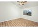 Well-lit bedroom with wood-look floors and a large window at 9920 W Calle Encorvada --, Phoenix, AZ 85037