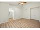 Bright bedroom with wood-look floors and ceiling fan at 9920 W Calle Encorvada --, Phoenix, AZ 85037