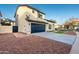 Two-story house with a side view showcasing the garage and landscaping at 9920 W Calle Encorvada --, Phoenix, AZ 85037