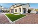 Two-story house with a walkway leading to the front door and artificial turf at 9920 W Calle Encorvada --, Phoenix, AZ 85037