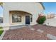 Front entrance with navy blue door and landscaping at 9920 W Calle Encorvada --, Phoenix, AZ 85037