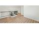 Loft hallway with wood-look floors and railing at 9920 W Calle Encorvada --, Phoenix, AZ 85037