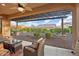 Relaxing backyard oasis with covered patio, wicker furniture, and desert landscaping at 12935 W Lone Tree Trl, Peoria, AZ 85383