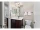 Cozy bathroom with dark wood vanity, a white vessel sink, neutral wall color, and white fixtures, including a toilet at 12935 W Lone Tree Trl, Peoria, AZ 85383