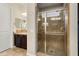 Bathroom featuring a glass enclosed shower and a single sink vanity with dark wood cabinets at 12935 W Lone Tree Trl, Peoria, AZ 85383