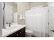 Clean bathroom with a dark wood vanity, neutral wall color, and white fixtures, including a toilet and shower at 12935 W Lone Tree Trl, Peoria, AZ 85383