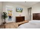 Bedroom featuring access to an outdoor patio and a television mounted on the wall at 12935 W Lone Tree Trl, Peoria, AZ 85383