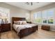 Bedroom features a wood-framed bed with shutters on the windows and wood-style flooring at 12935 W Lone Tree Trl, Peoria, AZ 85383