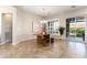 Well lit dining room features tile floors, shuttered windows, and backyard access via sliding glass doors at 12935 W Lone Tree Trl, Peoria, AZ 85383