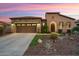 Single-story home with stone accents and landscaped front yard at 12935 W Lone Tree Trl, Peoria, AZ 85383