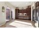 Bright kitchen with tiled floors, custom wood cabinets, stainless steel appliances, and sliding glass doors to the courtyard at 12935 W Lone Tree Trl, Peoria, AZ 85383