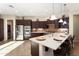 Spacious kitchen boasts stainless steel appliances, dark cabinetry, and a large center island with seating at 12935 W Lone Tree Trl, Peoria, AZ 85383