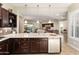 Gourmet kitchen showcases dark wood cabinetry, tile backsplash, stainless steel appliances, and quartz counters at 12935 W Lone Tree Trl, Peoria, AZ 85383