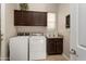 Laundry room featuring a washer and dryer with upper cabinets and countertop space at 12935 W Lone Tree Trl, Peoria, AZ 85383