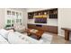 Comfortable living room features custom built-ins, a wine rack, and a large flat screen television at 12935 W Lone Tree Trl, Peoria, AZ 85383