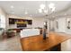 Open concept living room featuring tile floors, modern lighting, and custom built-in cabinetry at 12935 W Lone Tree Trl, Peoria, AZ 85383