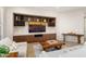 Cozy living room featuring custom built-ins with a wine rack, and comfortable seating arrangements at 12935 W Lone Tree Trl, Peoria, AZ 85383